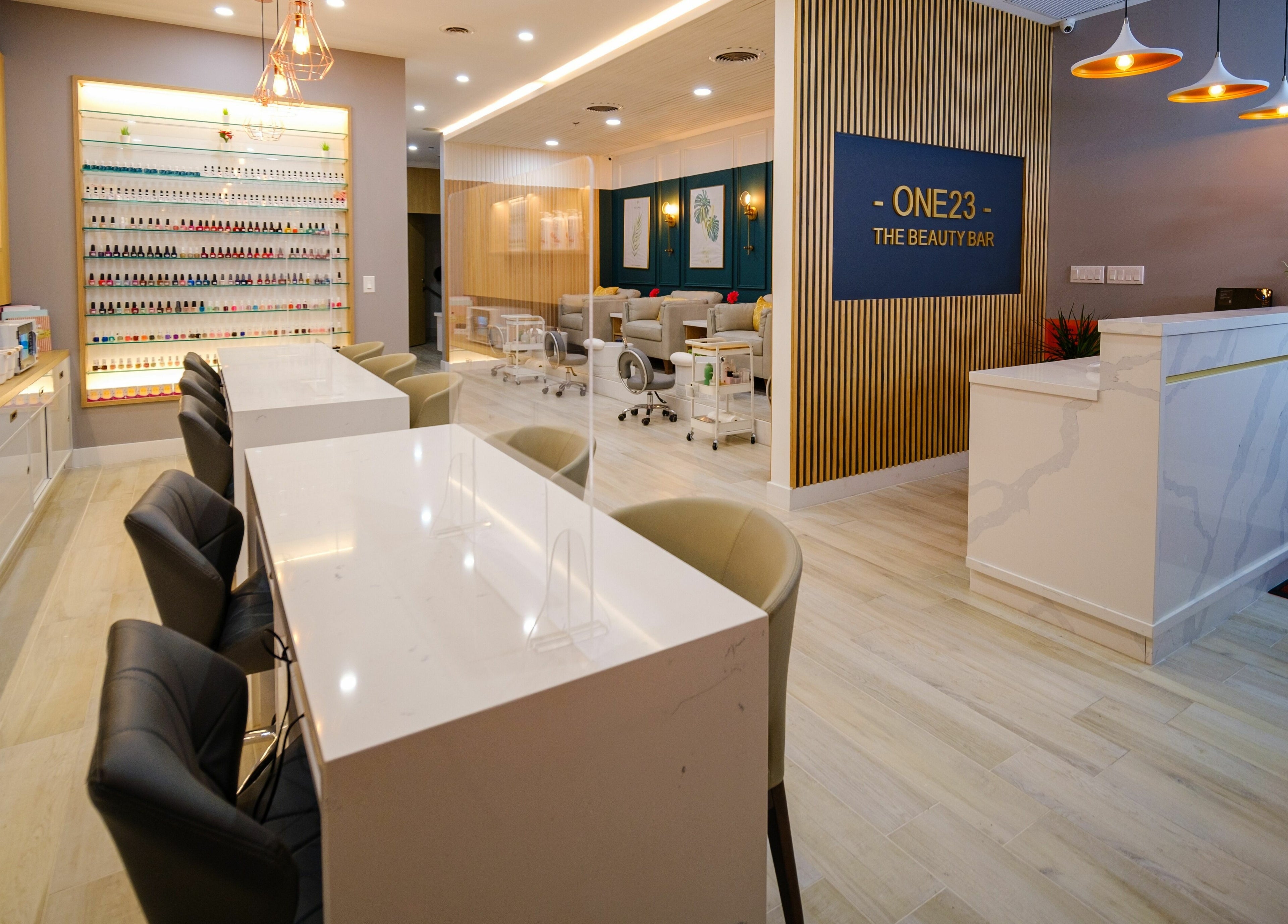 Modern interior of One23 Beauty Bar in Vaughan, Ontario, CA, showcasing chic manicure stations and elegant decor.