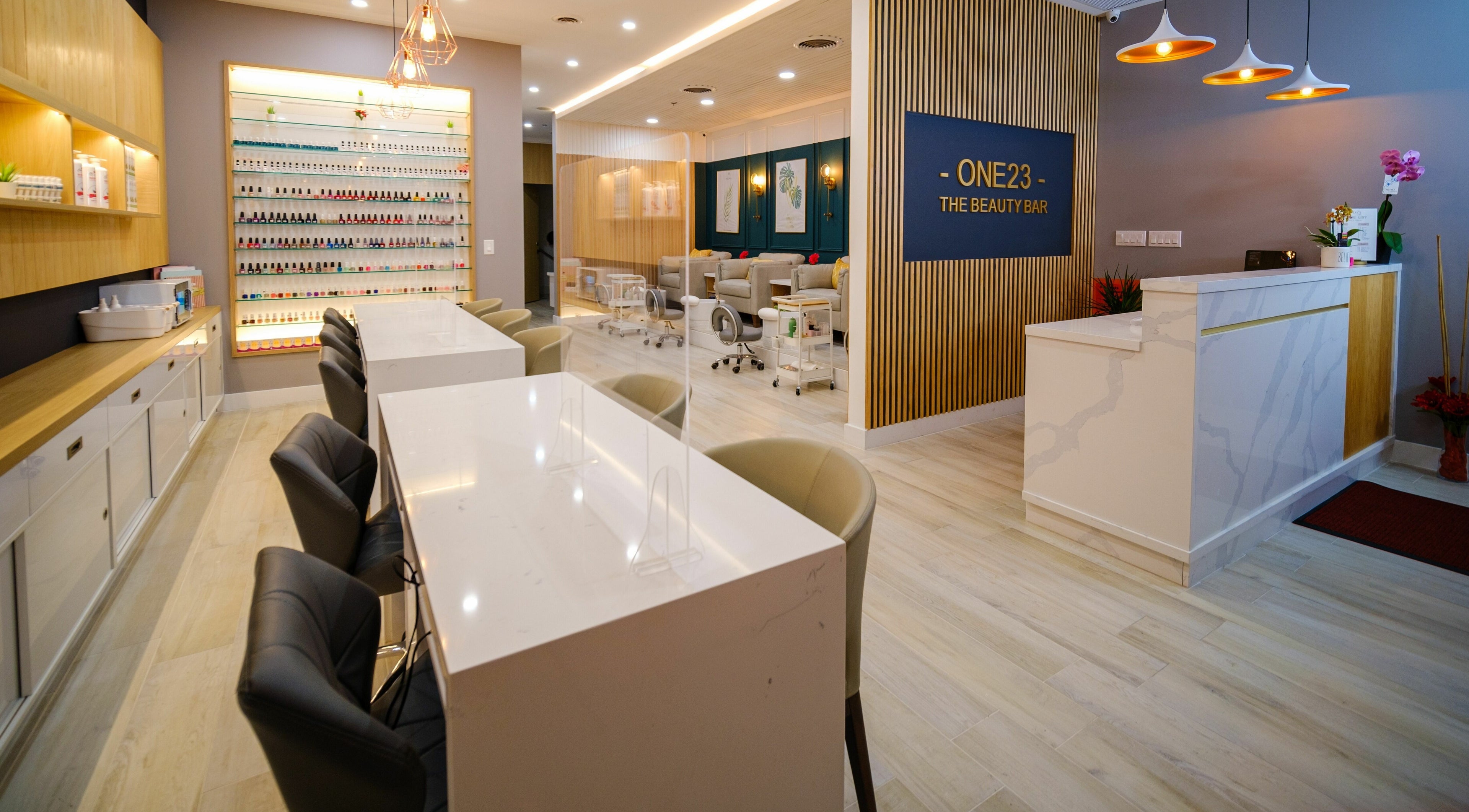 Modern interior of One23 Beauty Bar in Vaughan, Ontario, CA, showcasing chic manicure stations and elegant decor.