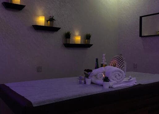 Tranquil massage room at Faisalia Center, Dammam, featuring soft lighting and plush towels.