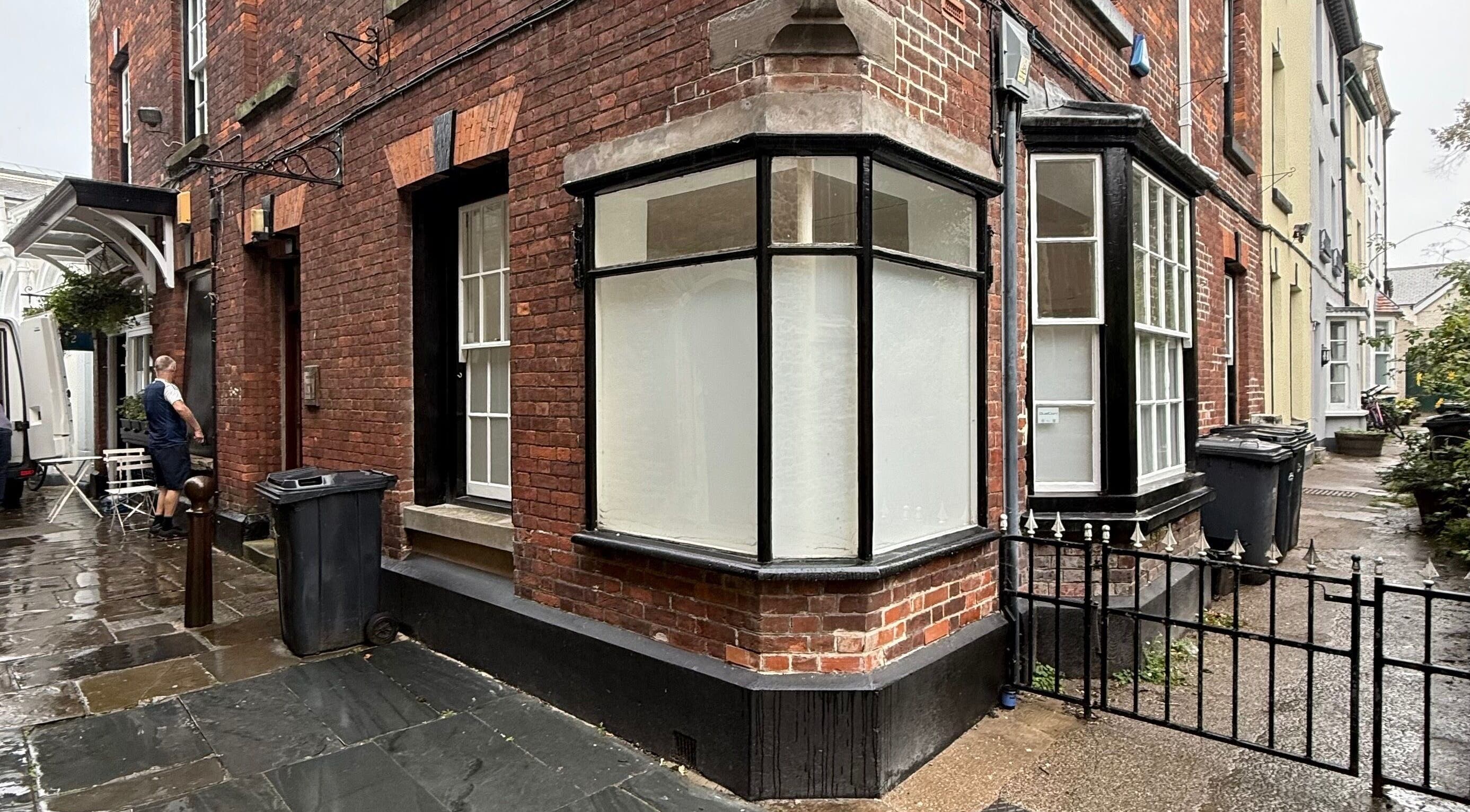 Charming brick exterior of Fleur Beauty | Skin and Wellbeing, Barnstaple, England, GB on a rainy day.