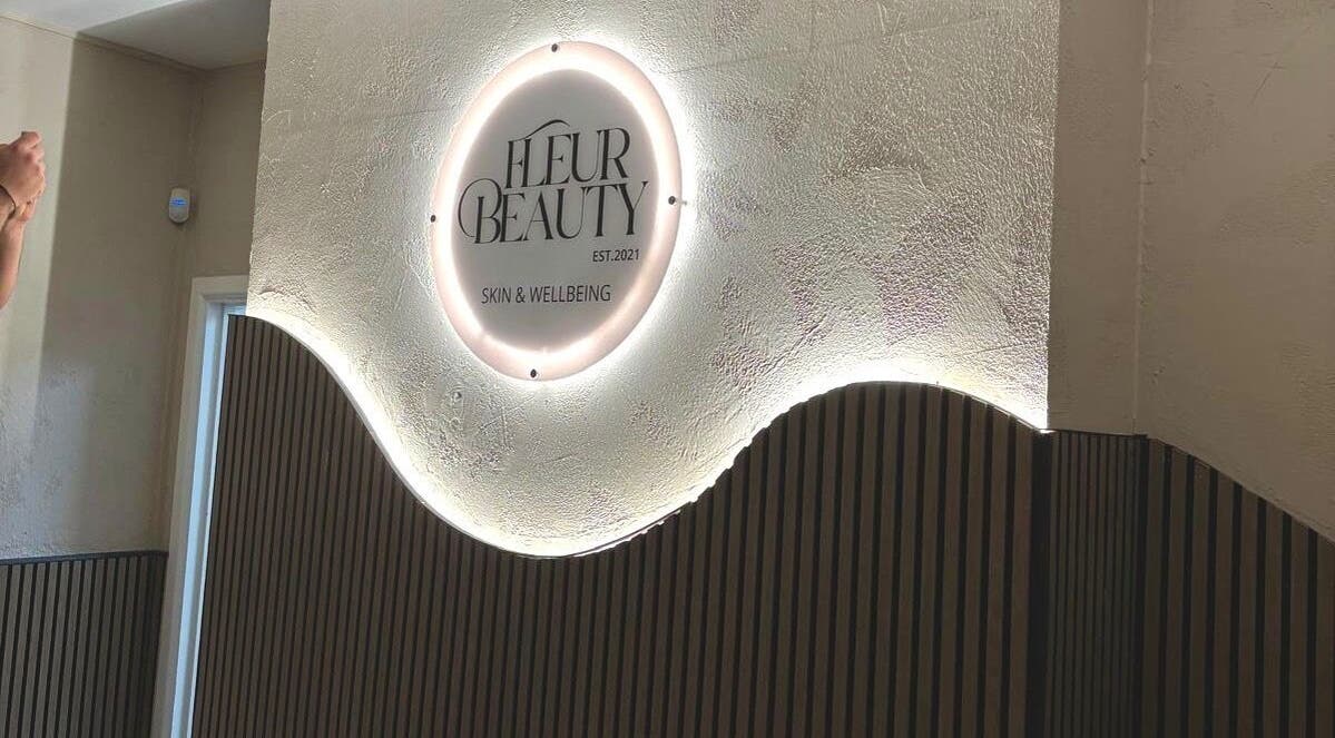 Illuminated sign at Fleur Beauty | Skin and Wellbeing in Barnstaple, England, GB featuring modern interior.