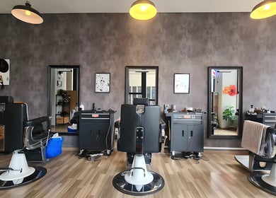 Modern barber chairs at Envy Cuts, Singapore, SG, highlighting sleek interior design and style.