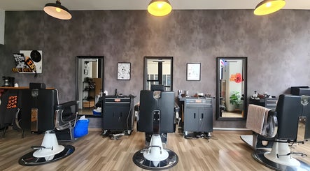 Modern barber chairs at Envy Cuts, Singapore, SG, highlighting sleek interior design and style.
