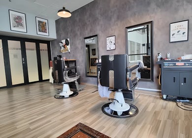 Modern interior of Envy Cuts, Singapore, SG, featuring stylish barber chairs and contemporary decor.