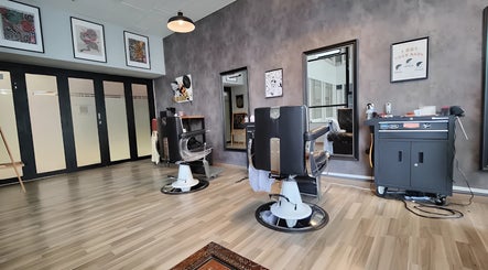 Modern interior of Envy Cuts, Singapore, SG, featuring stylish barber chairs and contemporary decor.