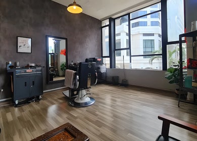 Bright and modern salon interior at Envy Cuts in Singapore, SG, featuring stylish chairs and large windows.