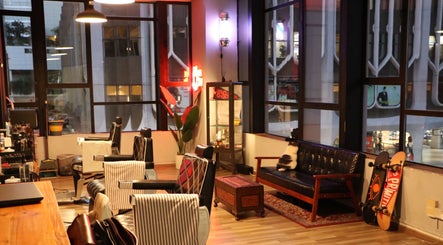 Cozy interior of Envy Cuts salon in Singapore, SG with stylish chairs and decor.
