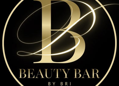 Elegant gold logo of Beauty Bar by Bri, Bridgetown, Saint James, BB, on a black background.