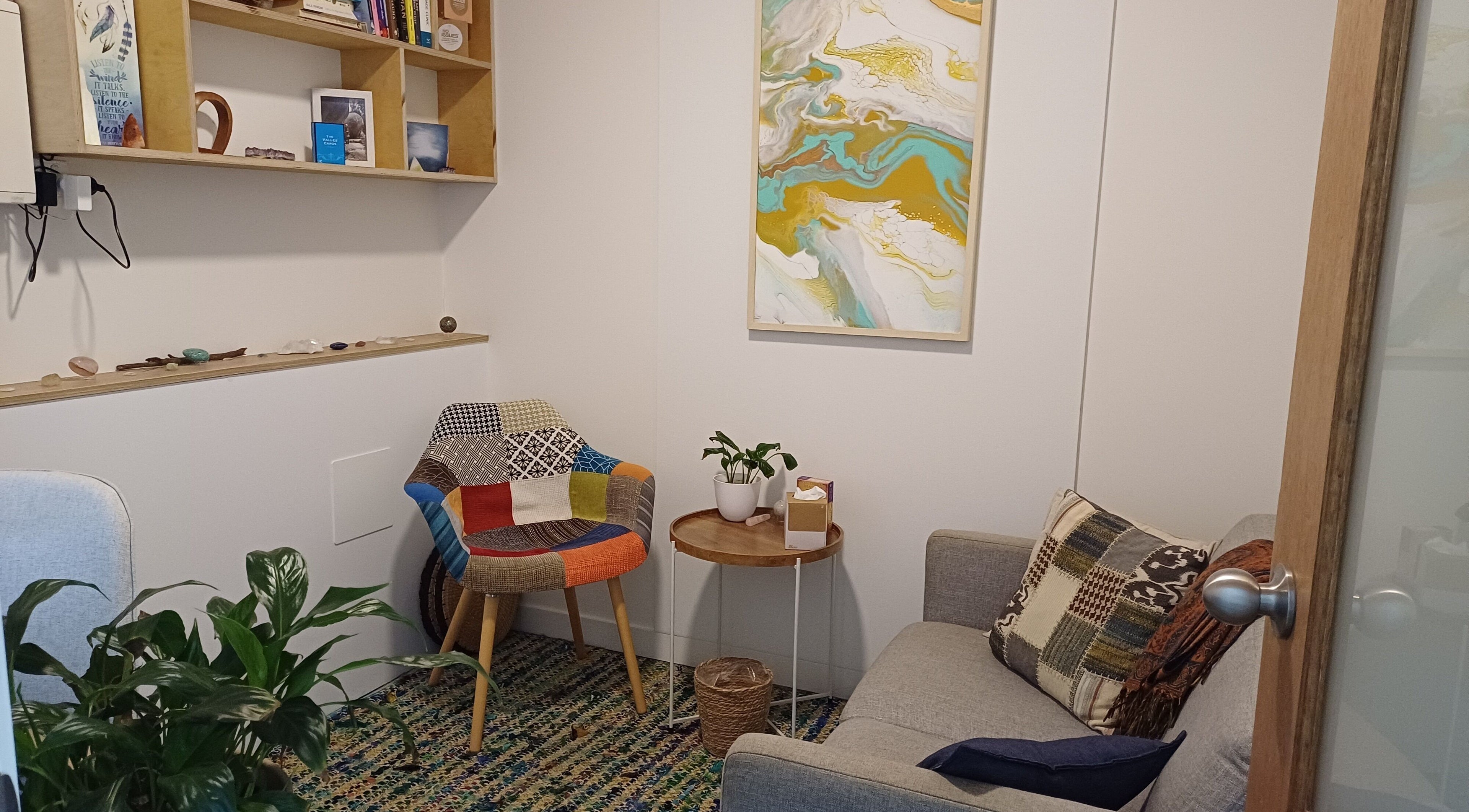 Charming room at Sacred Ground Australia, Palm Beach, Queensland, AU with colorful chair and art.