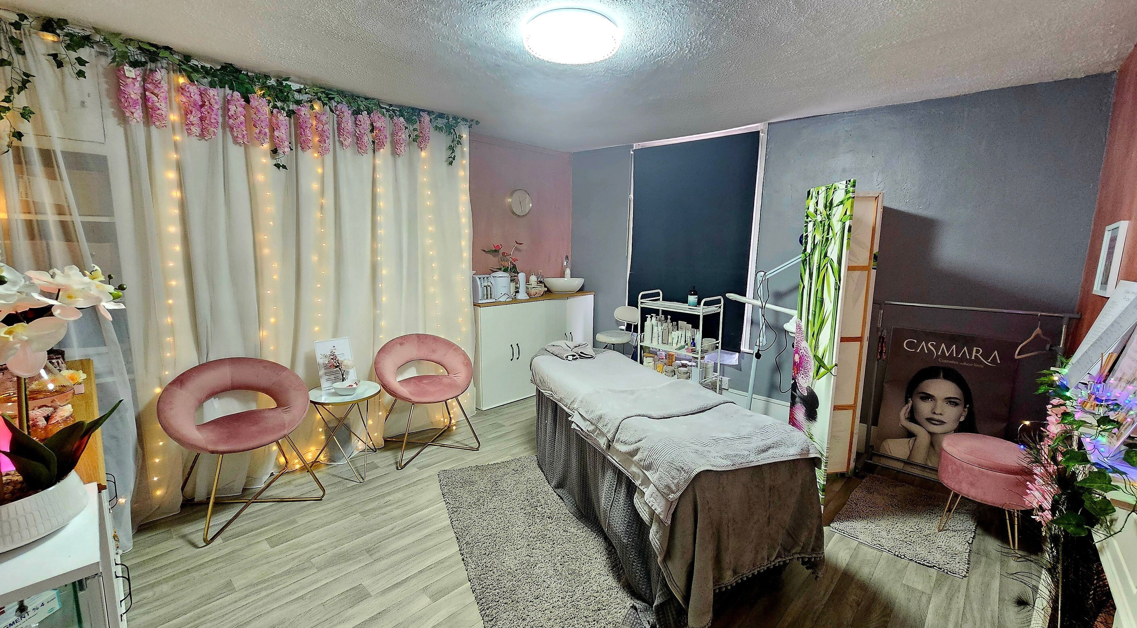 Elegant spa interior at Nadia's Beauty Room, Rochester, England, GB, featuring soft lighting and plush seating.