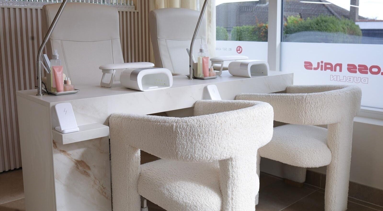 Elegant nail station at GLOSS Nails, Dublin, County Dublin, IE, featuring plush chairs and modern decor.