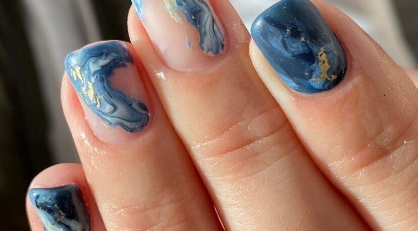 Blue marble nails with gold accents at Let's Relax, Park Gate, England, GB.