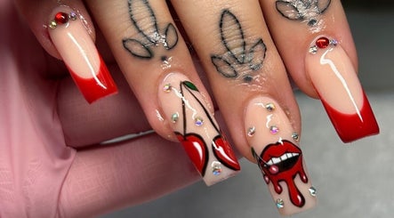 Bold cherry-themed nail art with red tips at The Beaut-E Club, Glasgow, Scotland, GB.
