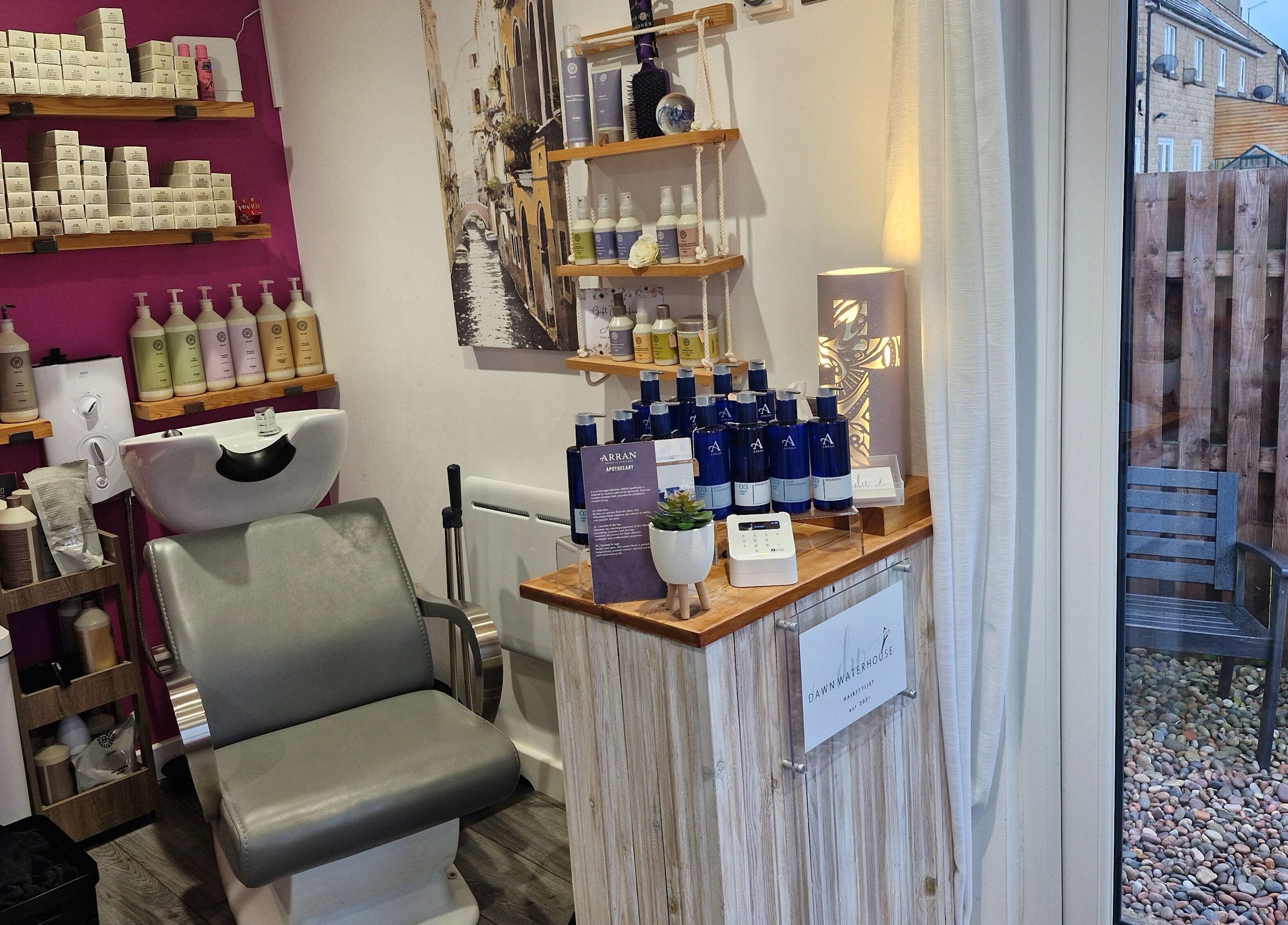Stylish interior of Dawn Waterhouse Salon in Skipton, England, featuring a hair wash station and beauty products.