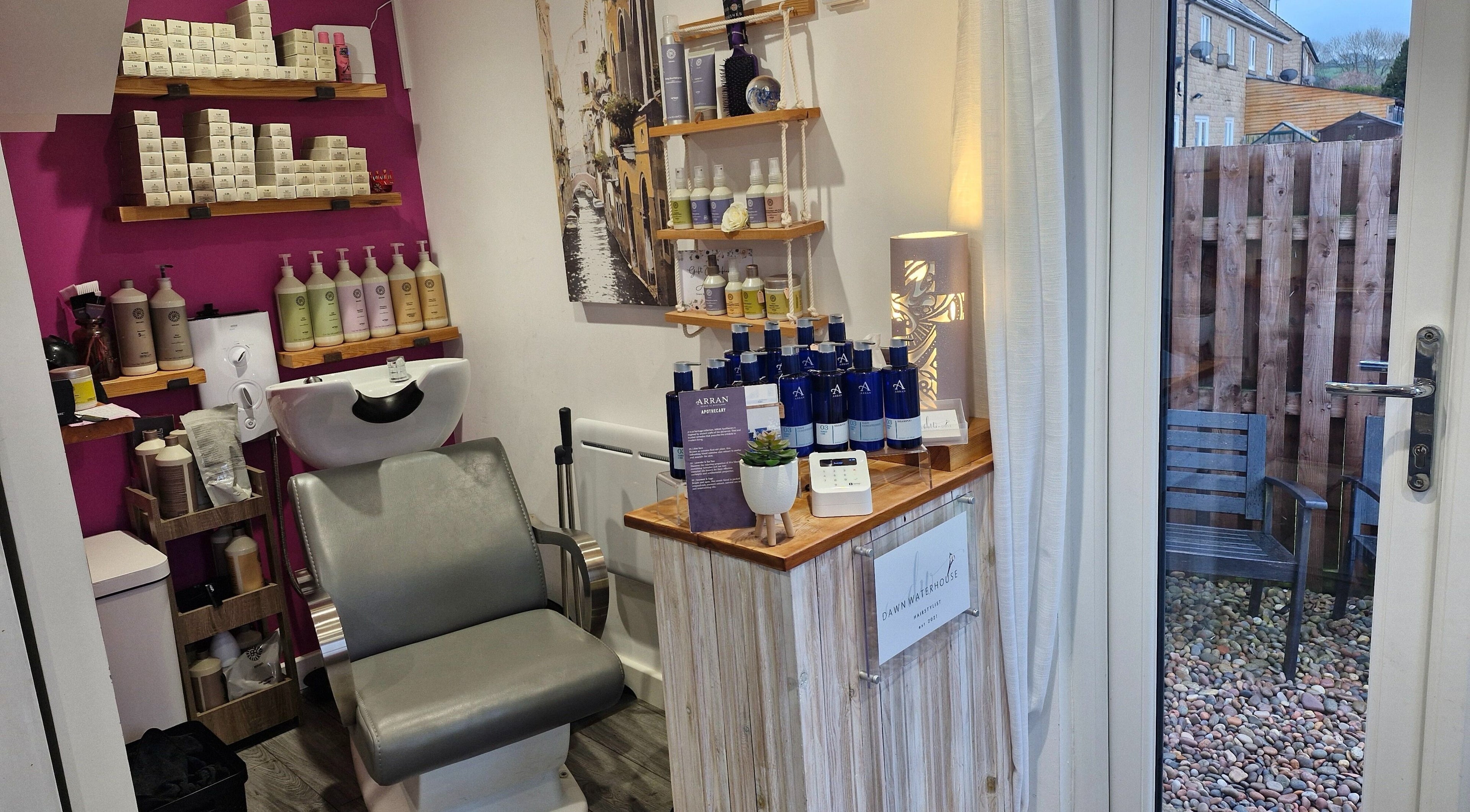 Stylish interior of Dawn Waterhouse Salon in Skipton, England, featuring a hair wash station and beauty products.