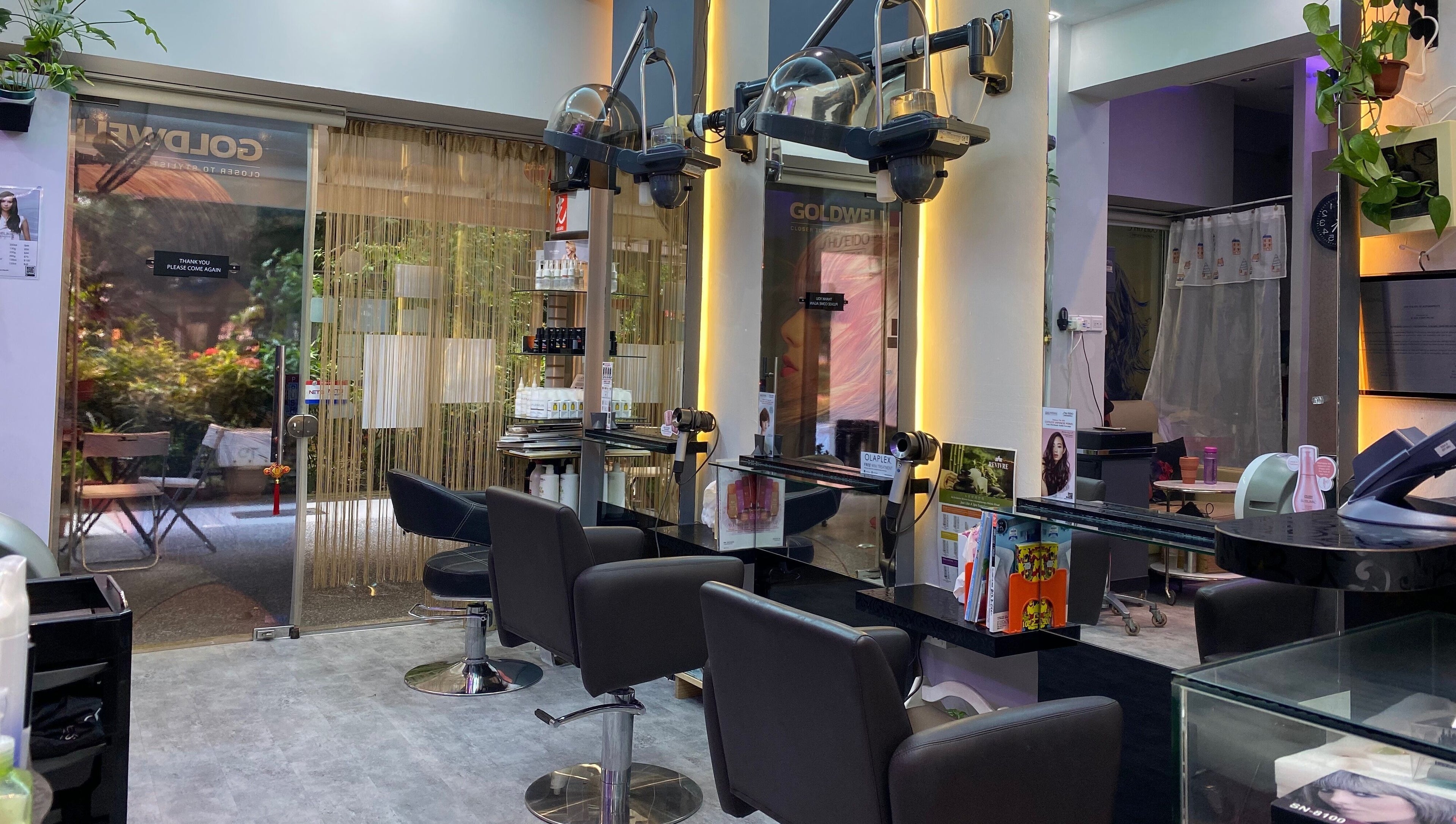 Interior view of Jo Hair Studio in Singapore, SG, featuring sleek styling chairs and mirrors.
