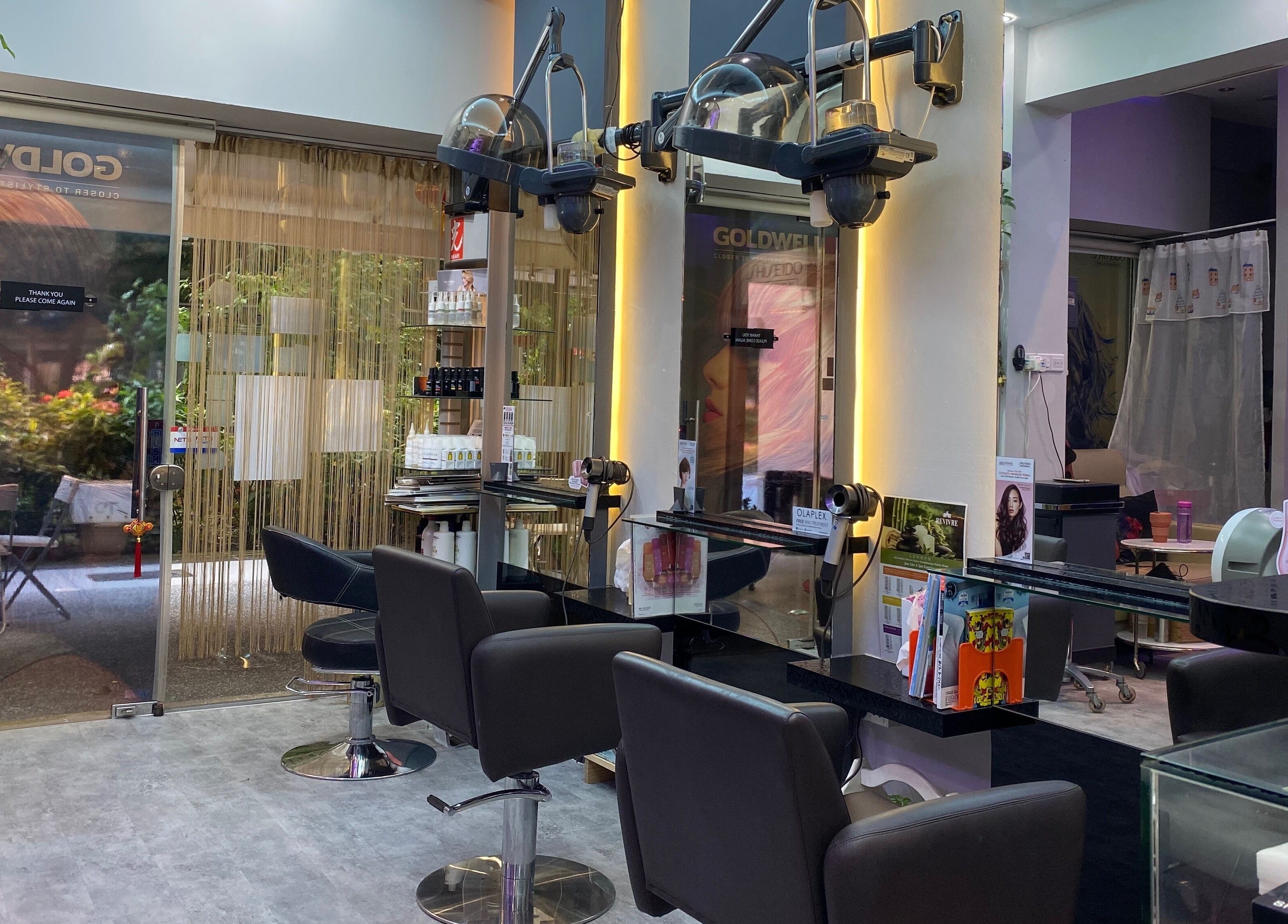 Interior view of Jo Hair Studio in Singapore, SG, featuring sleek styling chairs and mirrors.
