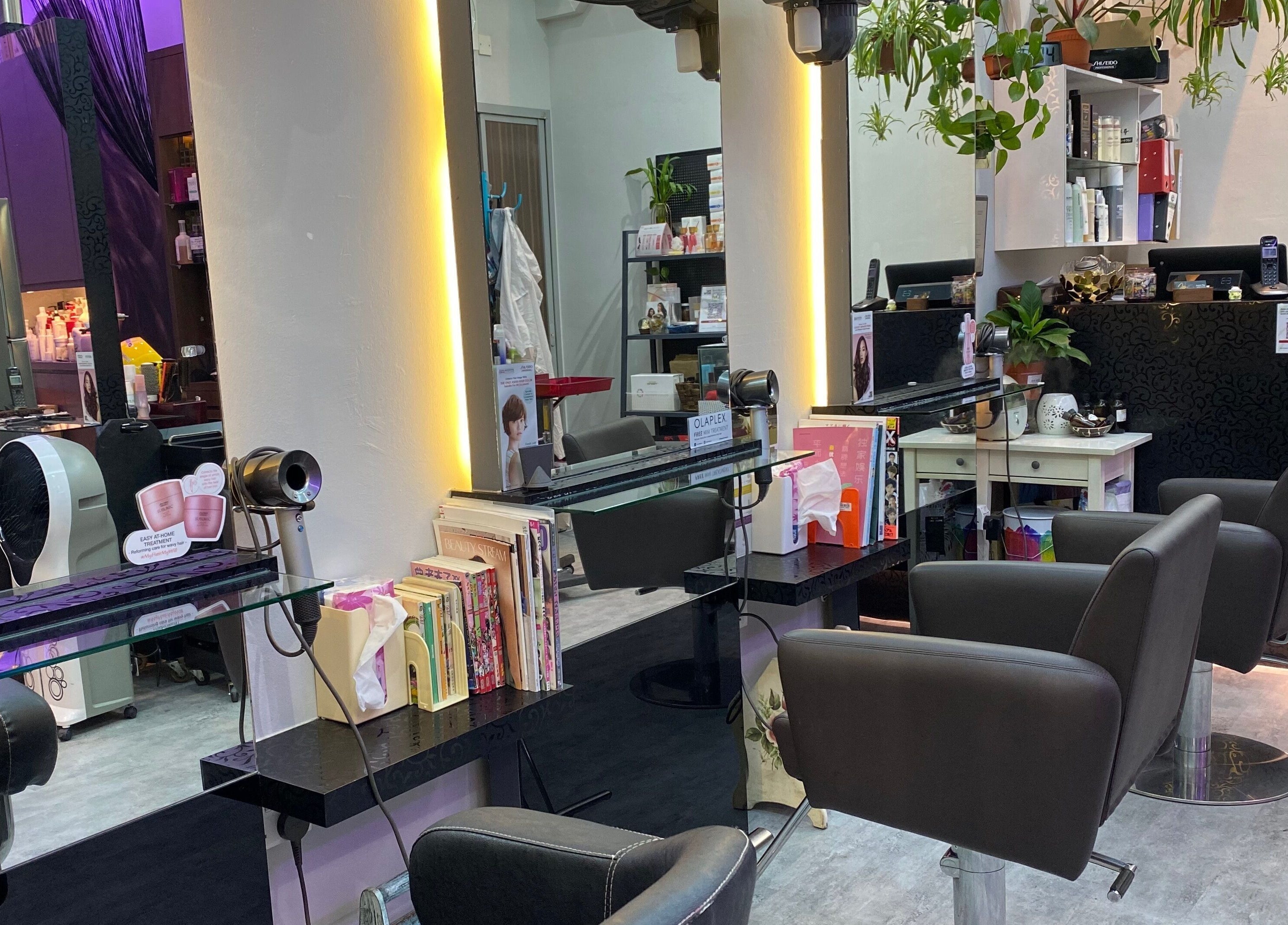 Modern interior of Jo Hair Studio, Singapore, SG. Elegant salon chairs and vibrant decor.