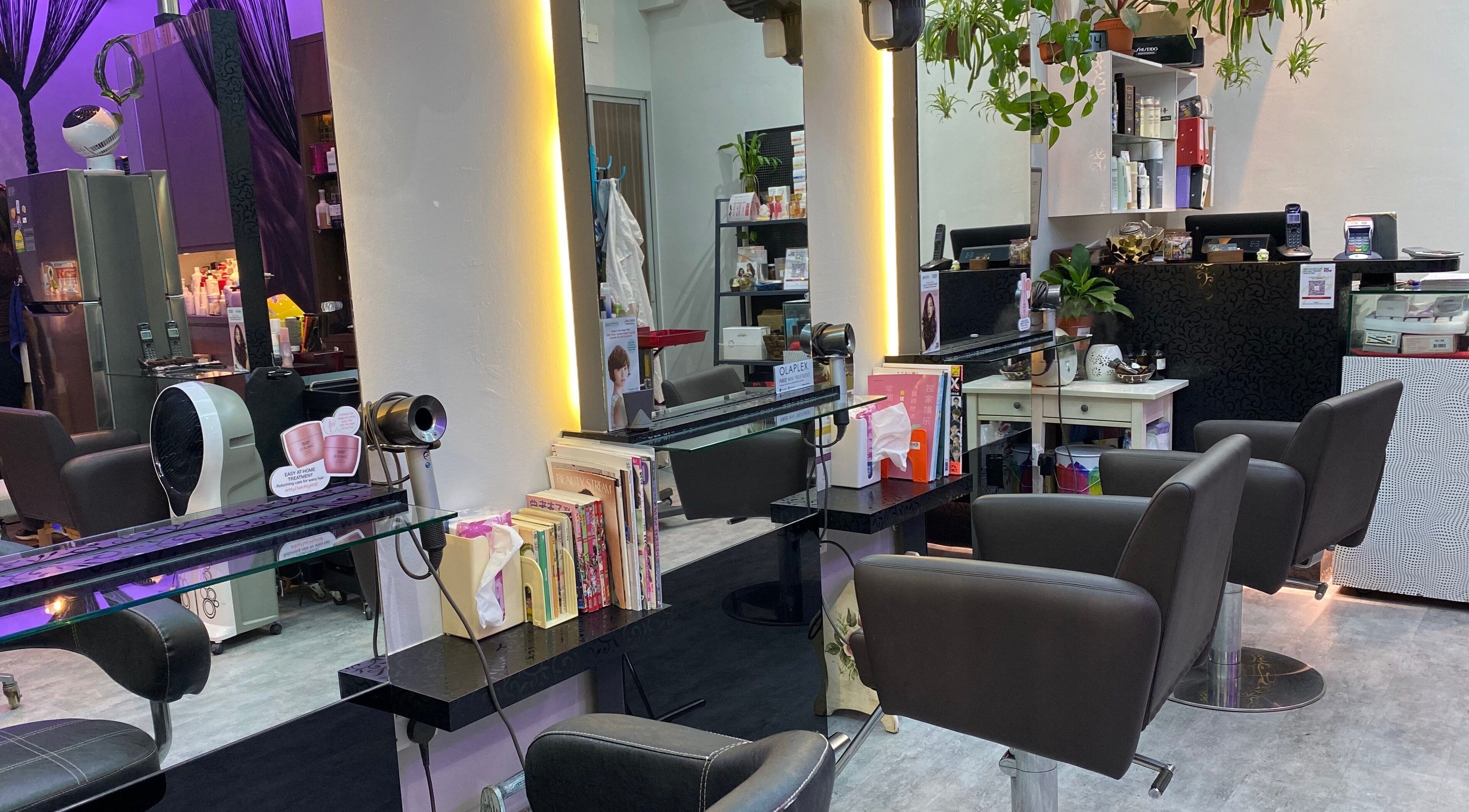 Modern interior of Jo Hair Studio, Singapore, SG. Elegant salon chairs and vibrant decor.