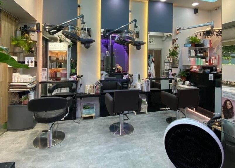 Modern interior of Jo Hair Studio in Singapore, Singapore, SG showcasing sleek salon stations and vibrant decor.