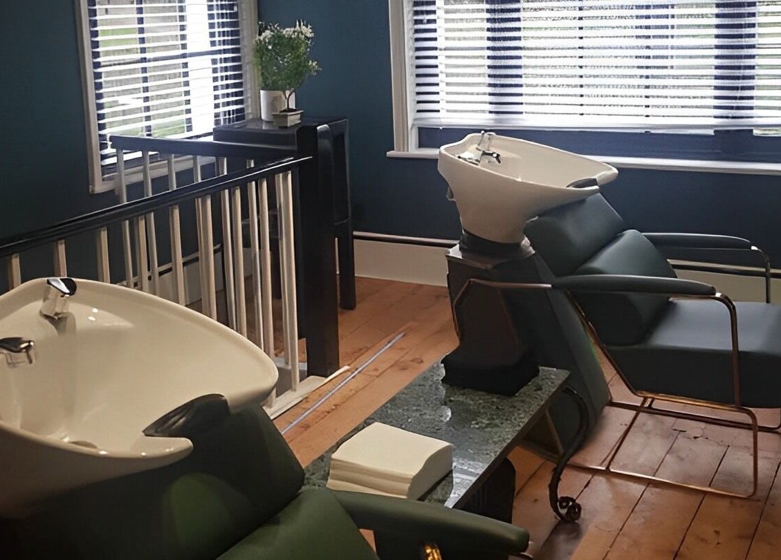 Luxurious hair wash stations at TAW in Tunbridge Wells, England, GB with sleek chairs and modern basins.