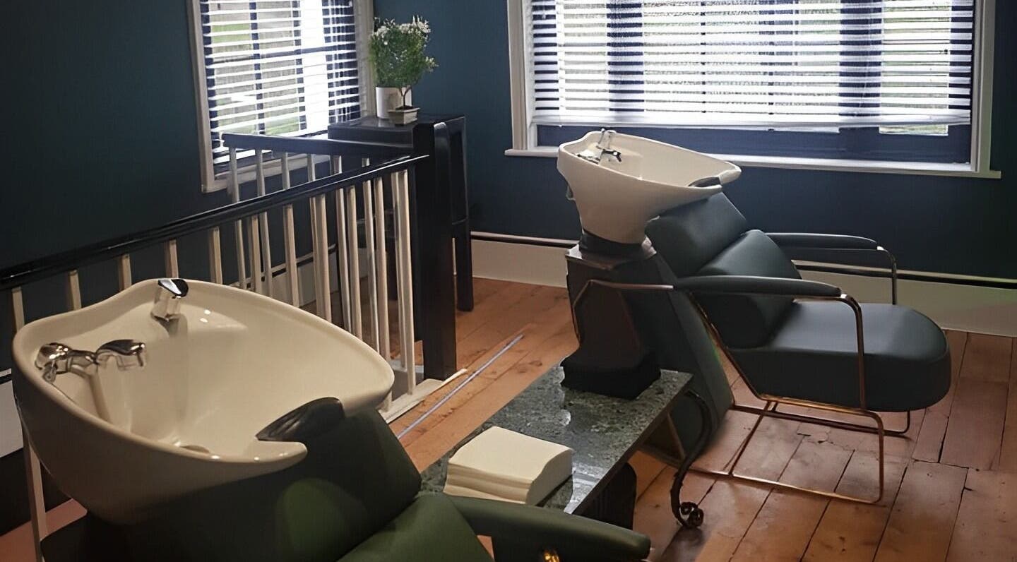 Luxurious hair wash stations at TAW in Tunbridge Wells, England, GB with sleek chairs and modern basins.