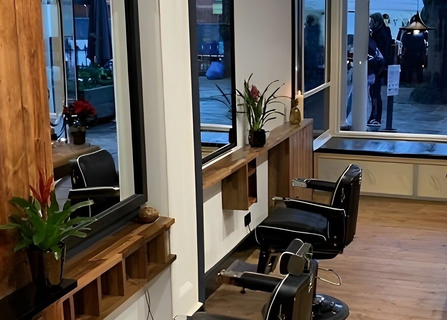 Modern salon interior at TAW, Tunbridge Wells, England, GB with stylish wooden decor and elegant barber chairs.
