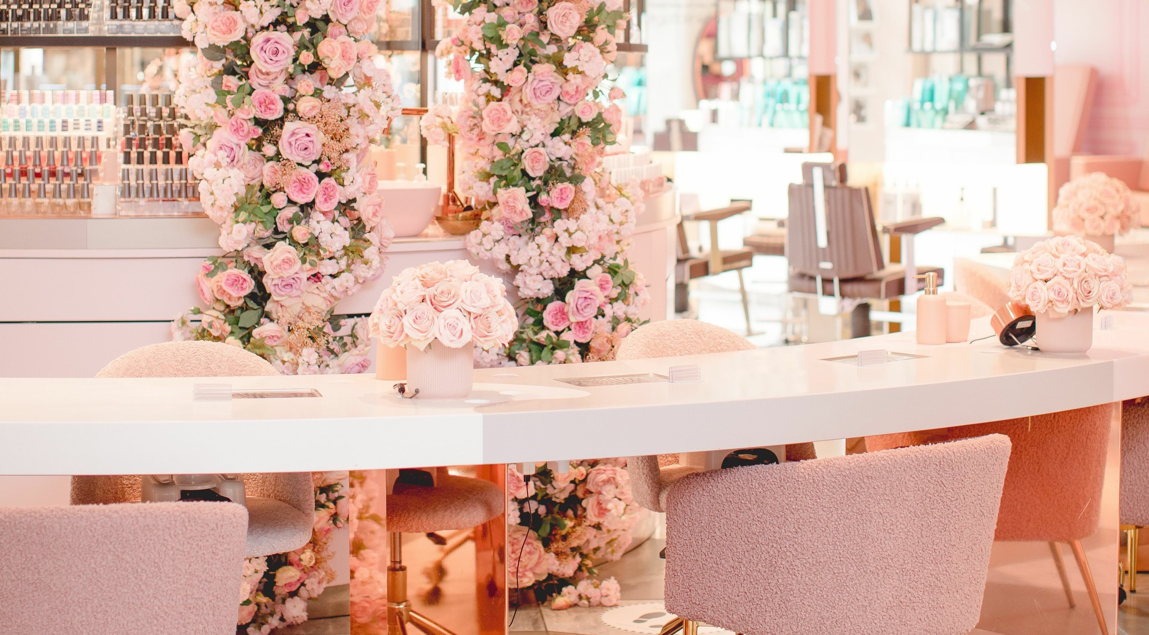 Luxurious nail salon at Nail'd It Knightsbridge, adorned with pink roses, located in London, England, GB.