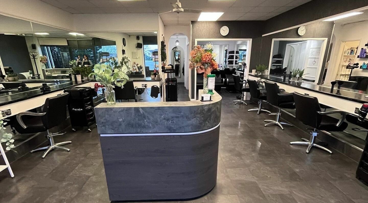 The Hair Company in Woolwell, England, GB offers a modern salon with sleek styling stations and welcoming decor.