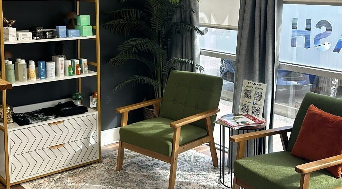 Cozy seating area with green chairs at Mad Wax in Largo, Florida, US featuring a stylish product shelf.