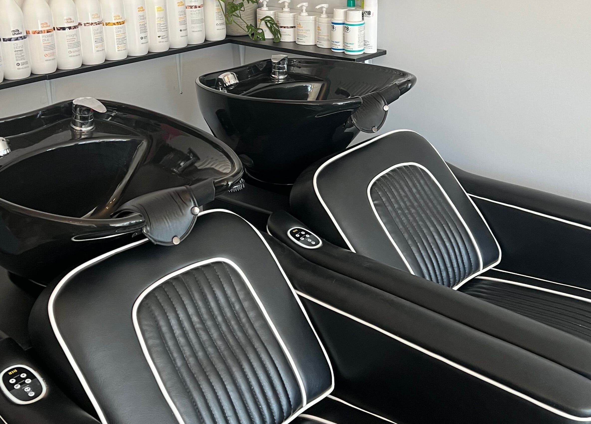 Elegant black wash stations at Reds, Hull, England, GB, offering premium hair care experience.