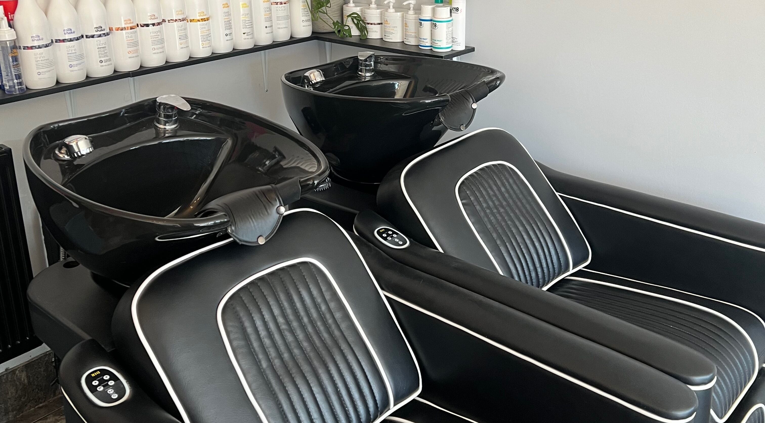 Elegant black wash stations at Reds, Hull, England, GB, offering premium hair care experience.