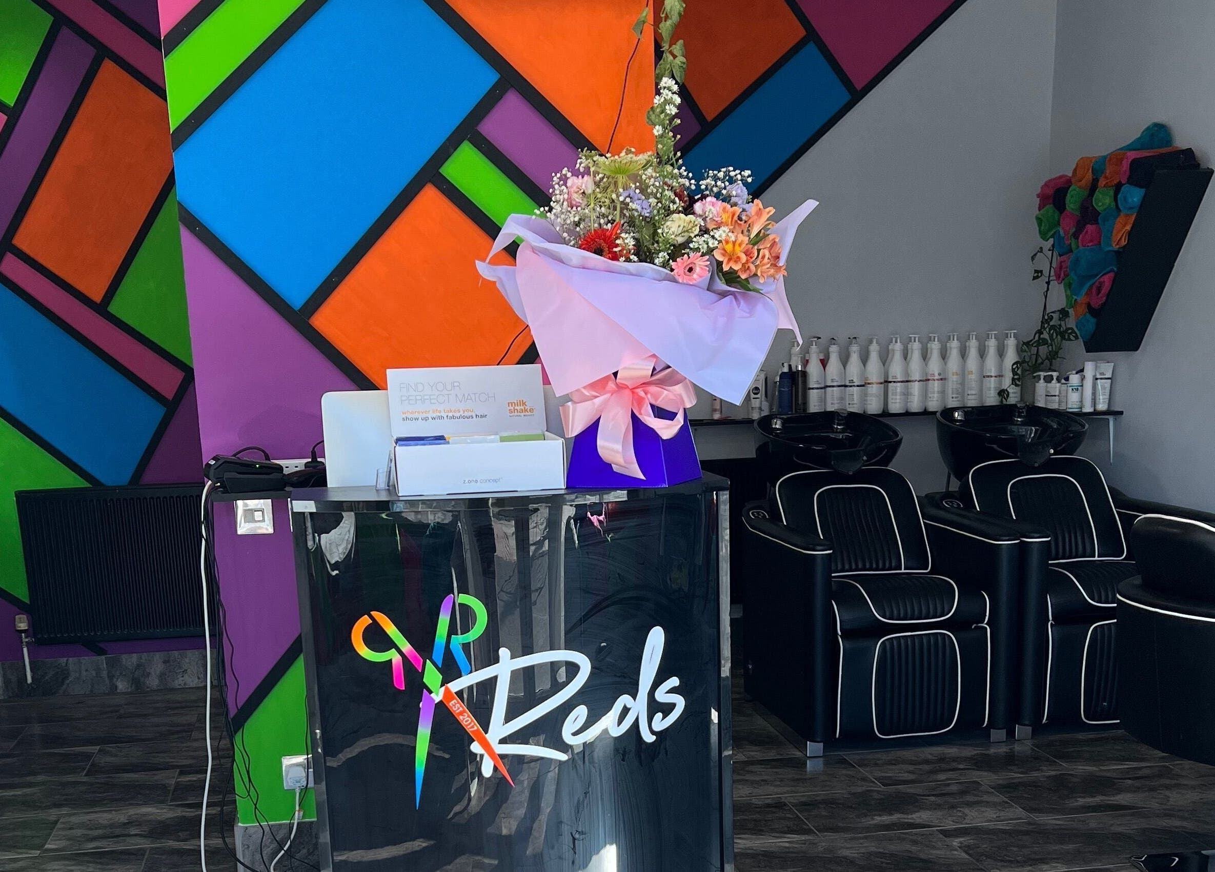 Colorful interior of Reds salon in Hull, England, GB, featuring modern decor with a welcoming ambience.
