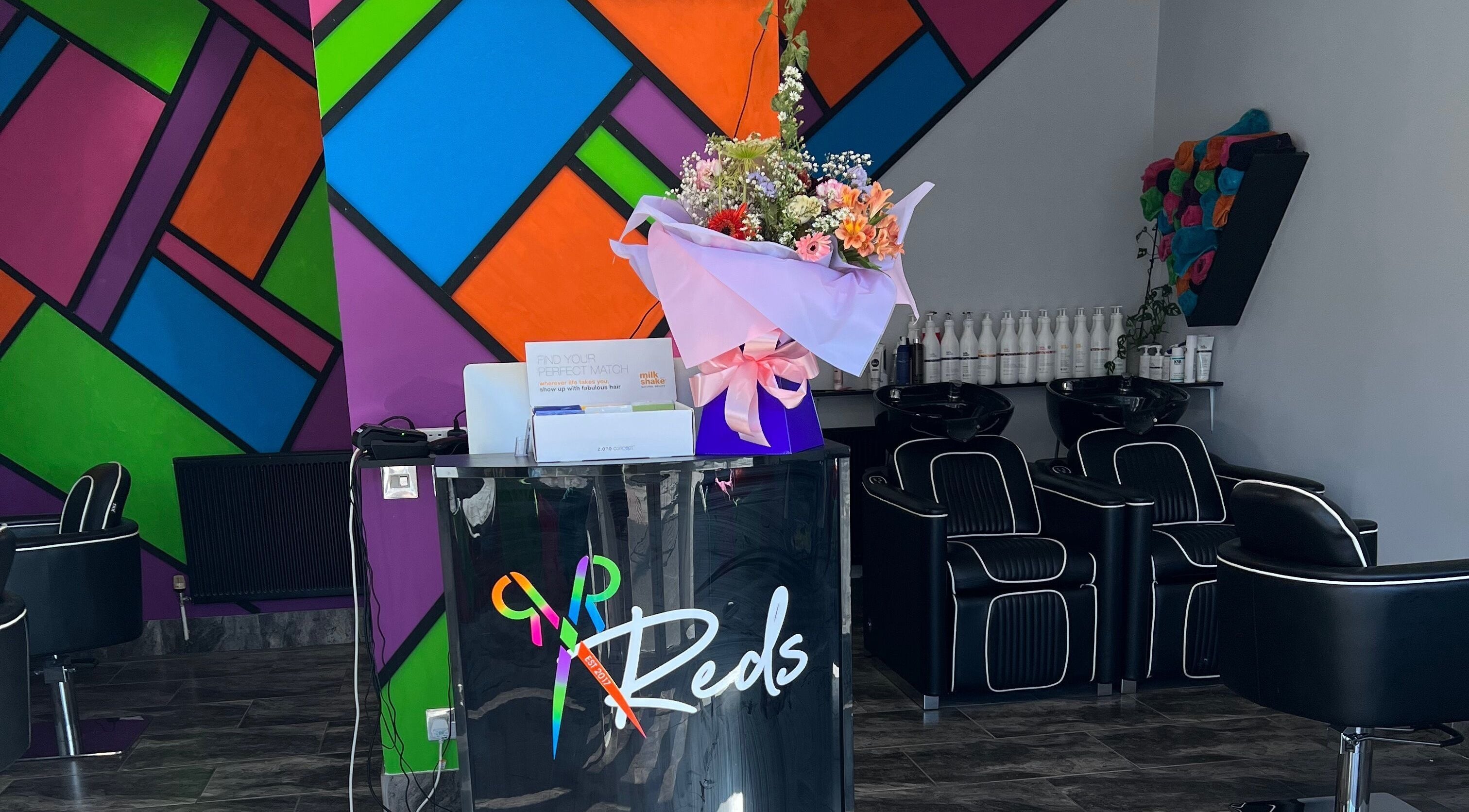 Colorful interior of Reds salon in Hull, England, GB, featuring modern decor with a welcoming ambience.