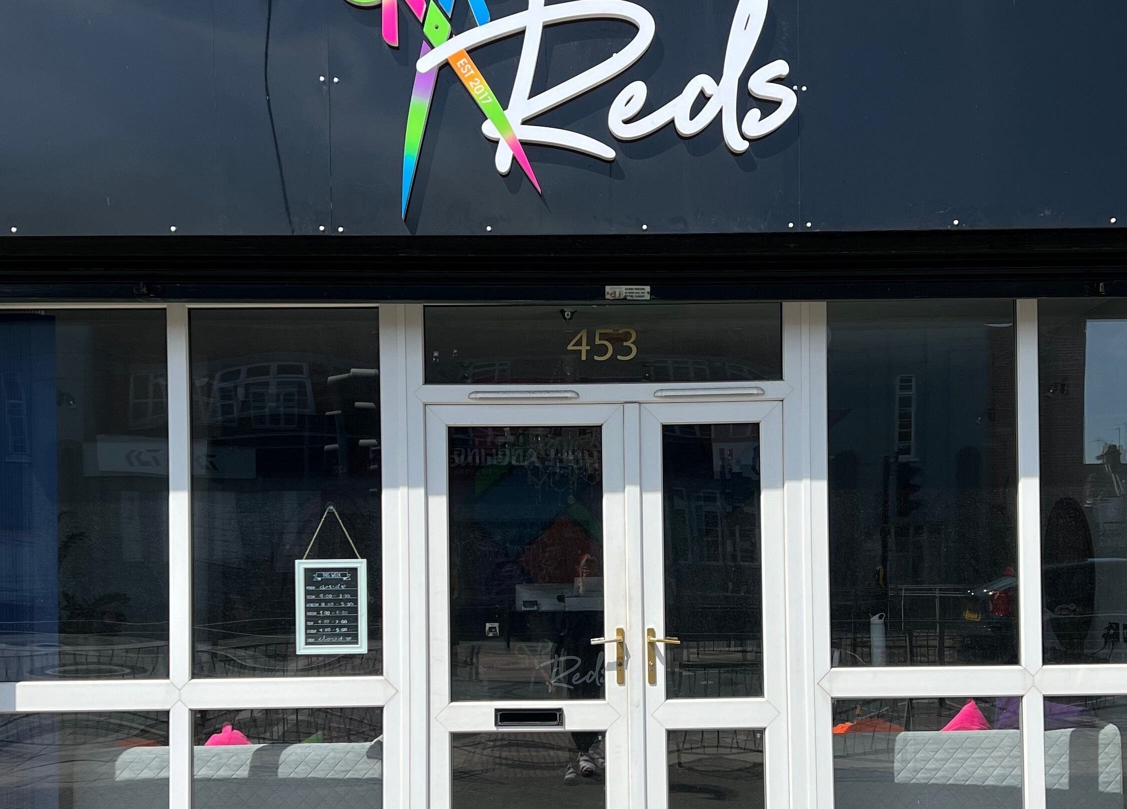 Front view of Reds beauty and wellness salon at 453 Hull, England, GB, showcasing its modern glass facade.