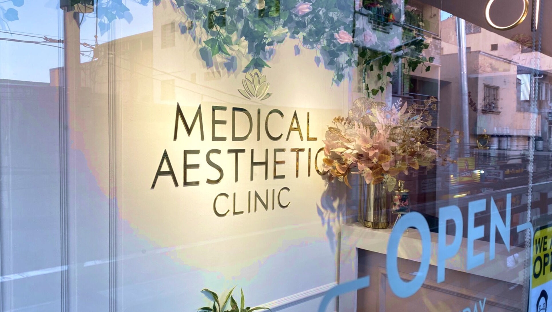 Exterior of Medical Aesthetic Clinic in Pasay, Metro Manila, PH with floral accents and open sign.