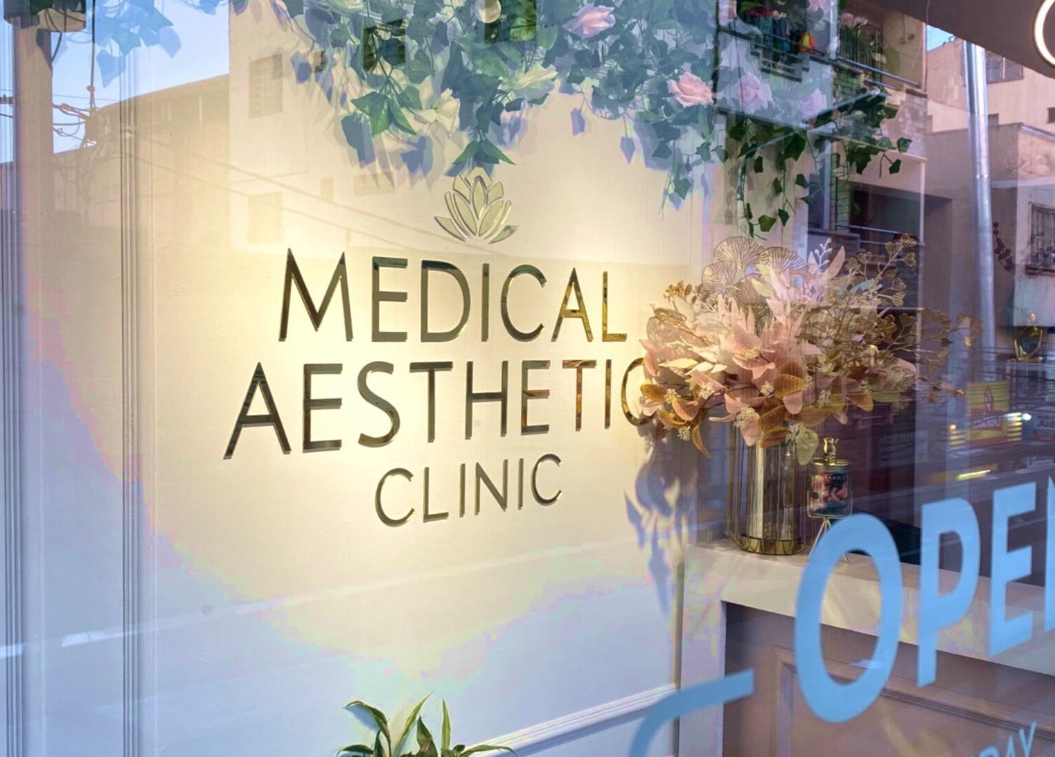 Exterior of Medical Aesthetic Clinic in Pasay, Metro Manila, PH with floral accents and open sign.