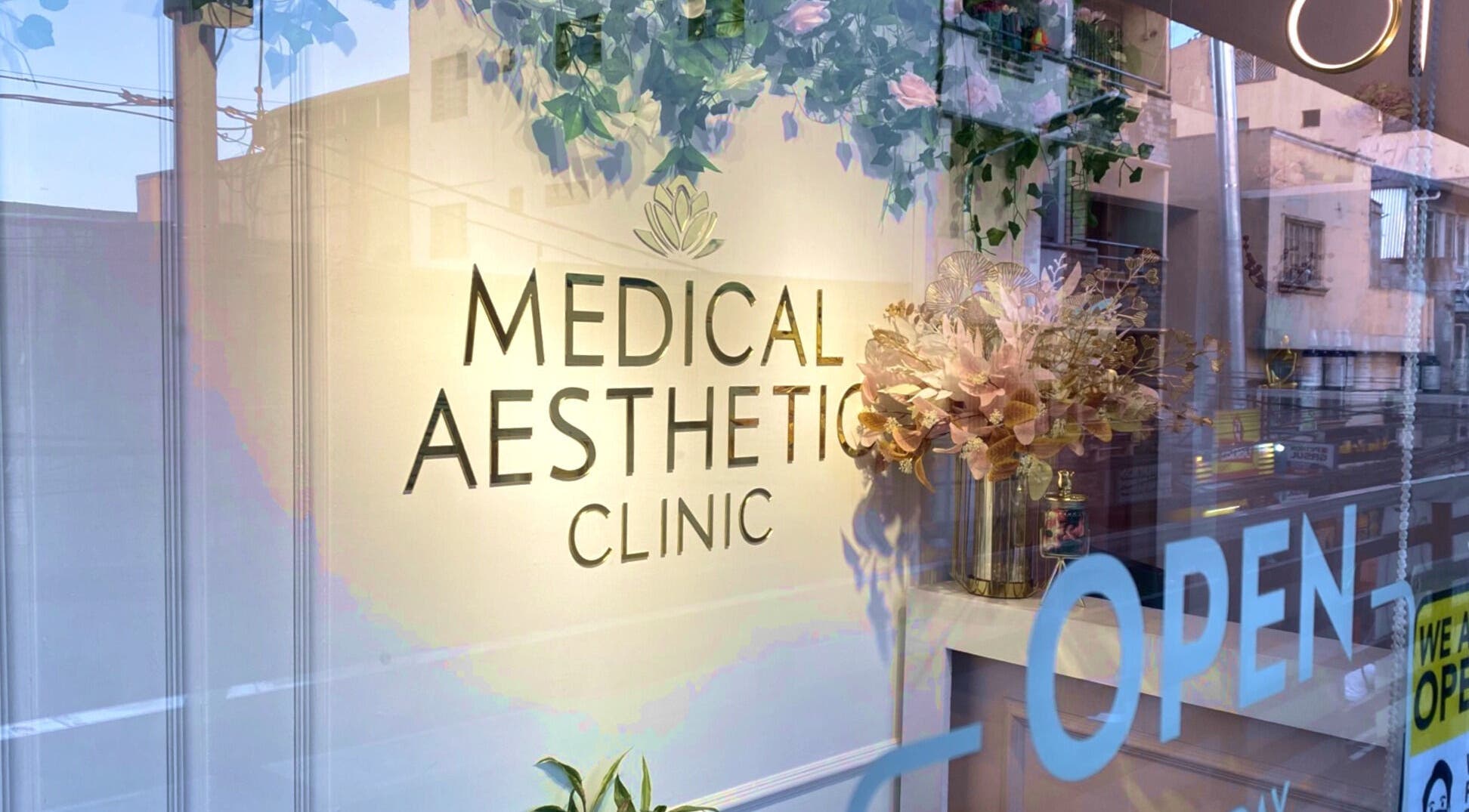 Exterior of Medical Aesthetic Clinic in Pasay, Metro Manila, PH with floral accents and open sign.