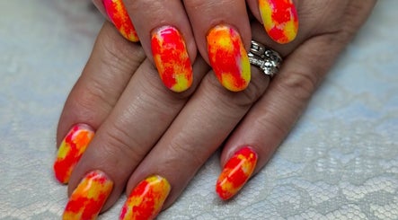Vibrant multicolor nail art at Pampered Beauties, Sheffield, England, GB showcasing intricate hand design.