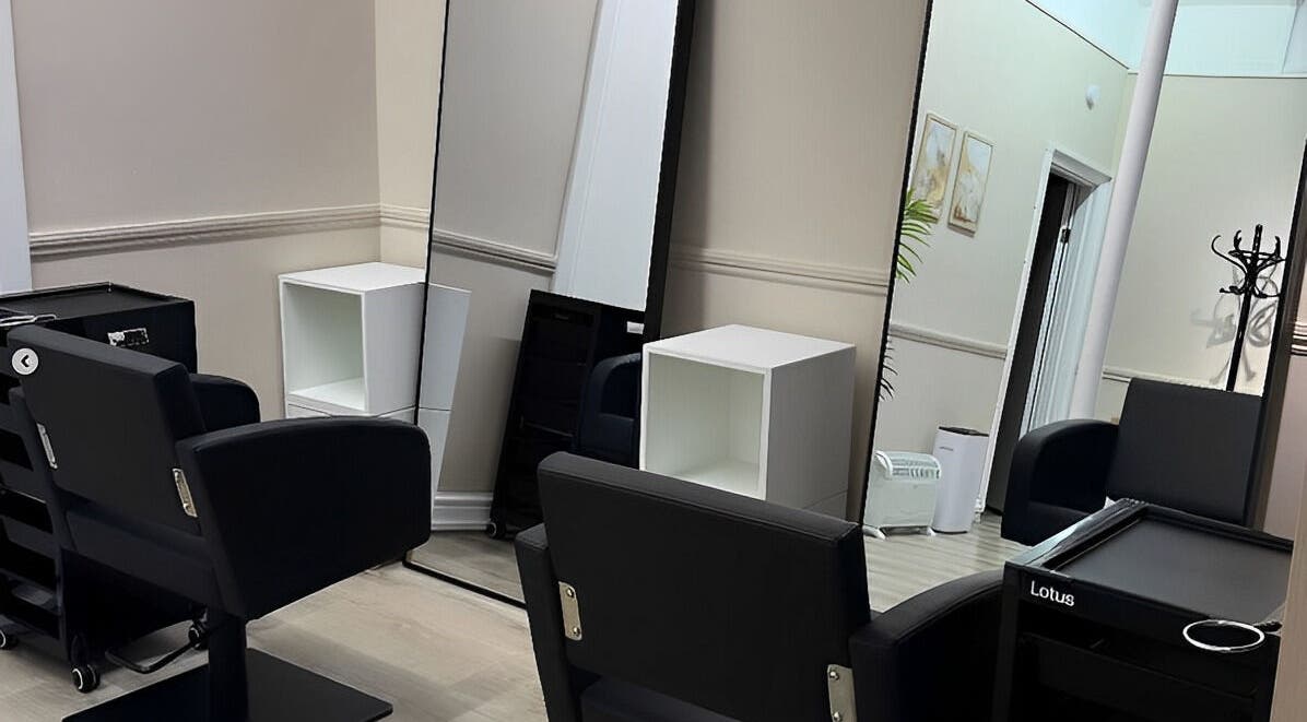 Modern salon interior at Belle Âme Beauty, Aldeburgh, England, GB with sleek salon chairs and mirrors.