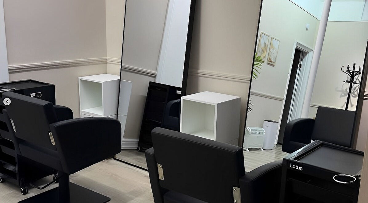 Modern salon interior at Belle Âme Beauty, Aldeburgh, England, GB with sleek salon chairs and mirrors.