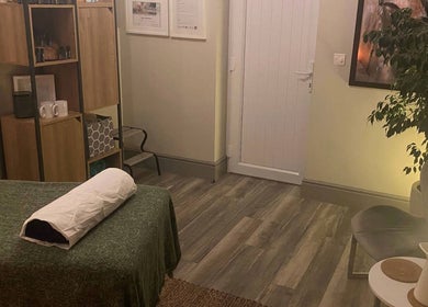 Cozy therapy room at Albion Massage Therapy, Cambridge, England, GB. Features a massage bed and calming decor.