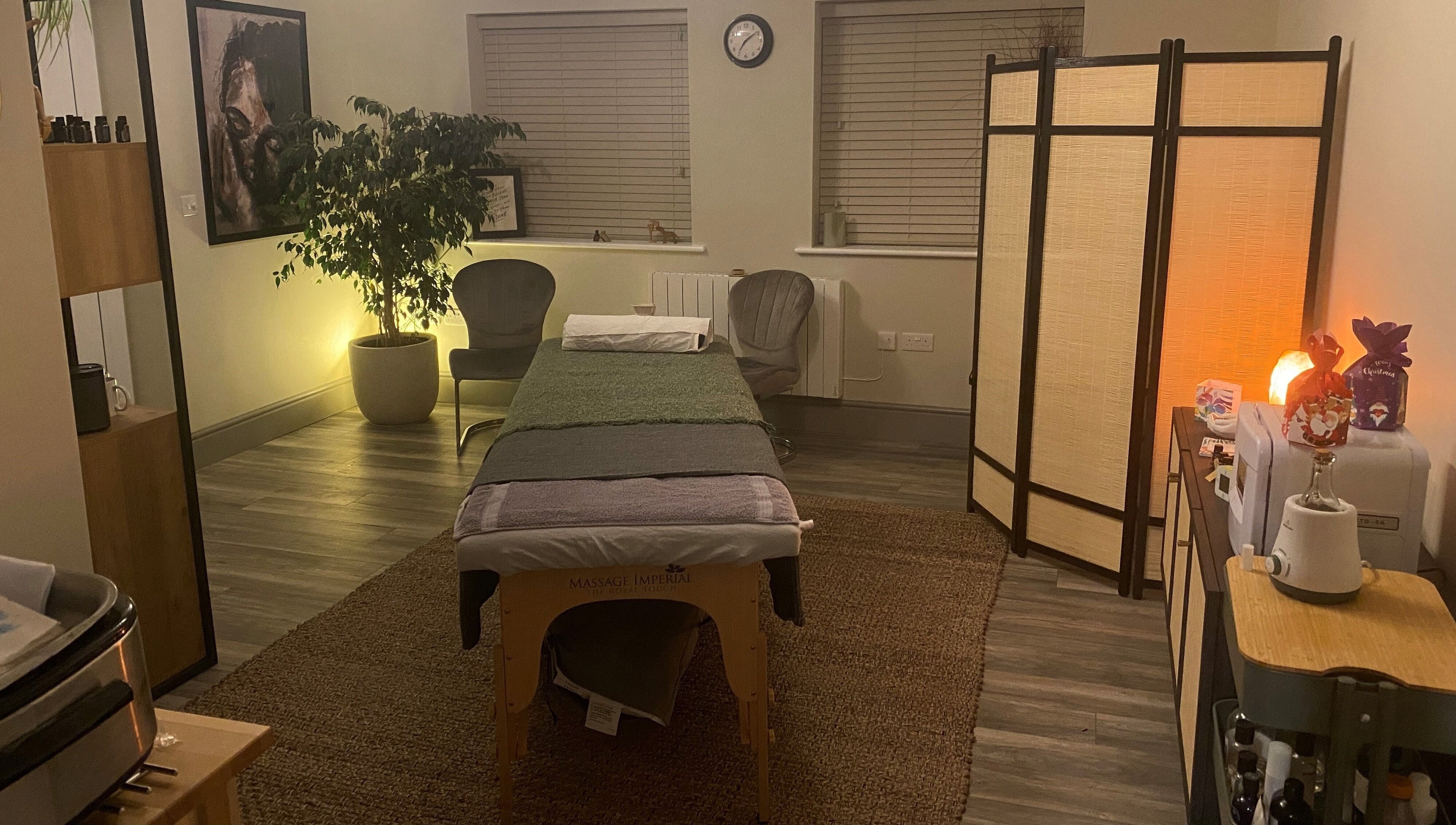 Relaxing massage room at Albion Massage Therapy in Cambridge, England, GB, featuring a cozy setup with dim lighting.