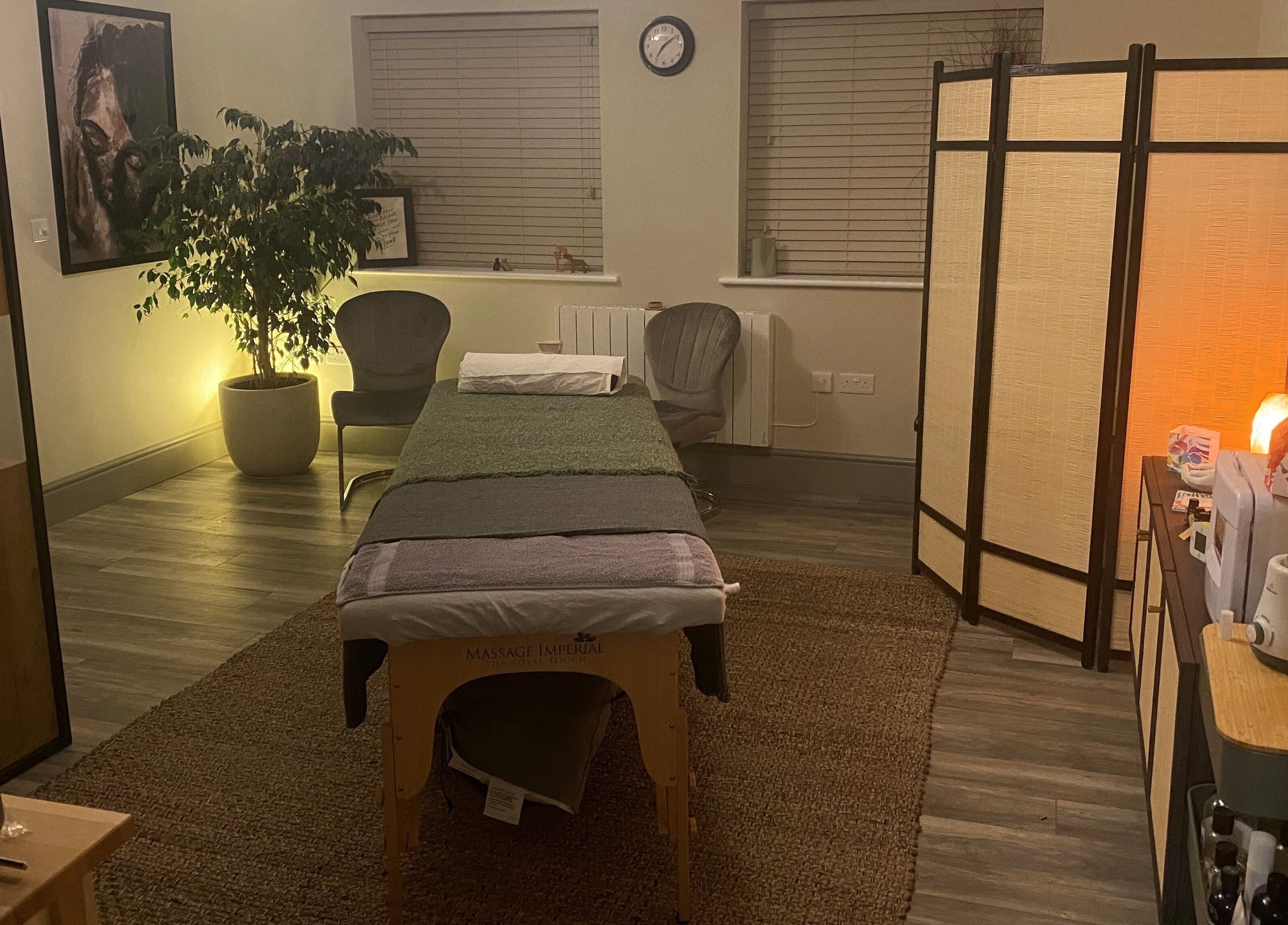 Relaxing massage room at Albion Massage Therapy in Cambridge, England, GB, featuring a cozy setup with dim lighting.