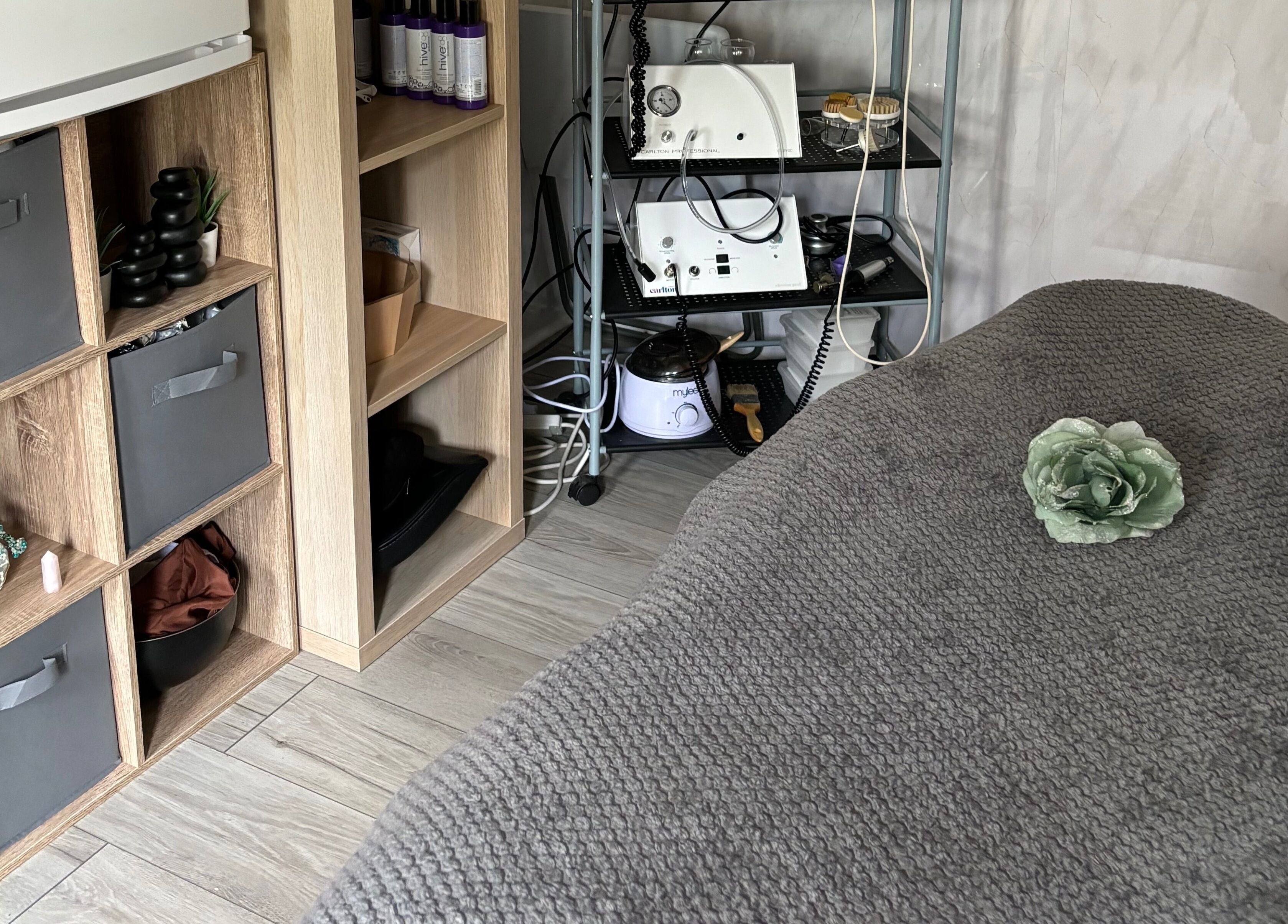 Cozy treatment room at Kerridwen, Cardiff, Wales, GB with elegant decor and beauty equipment.