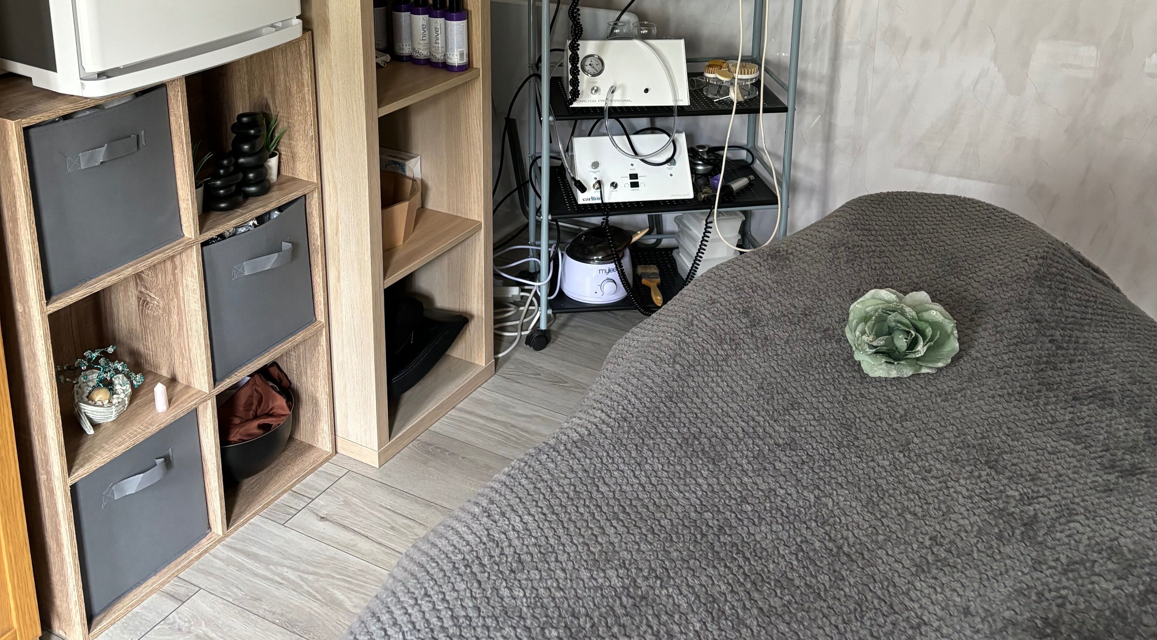 Cozy treatment room at Kerridwen, Cardiff, Wales, GB with elegant decor and beauty equipment.