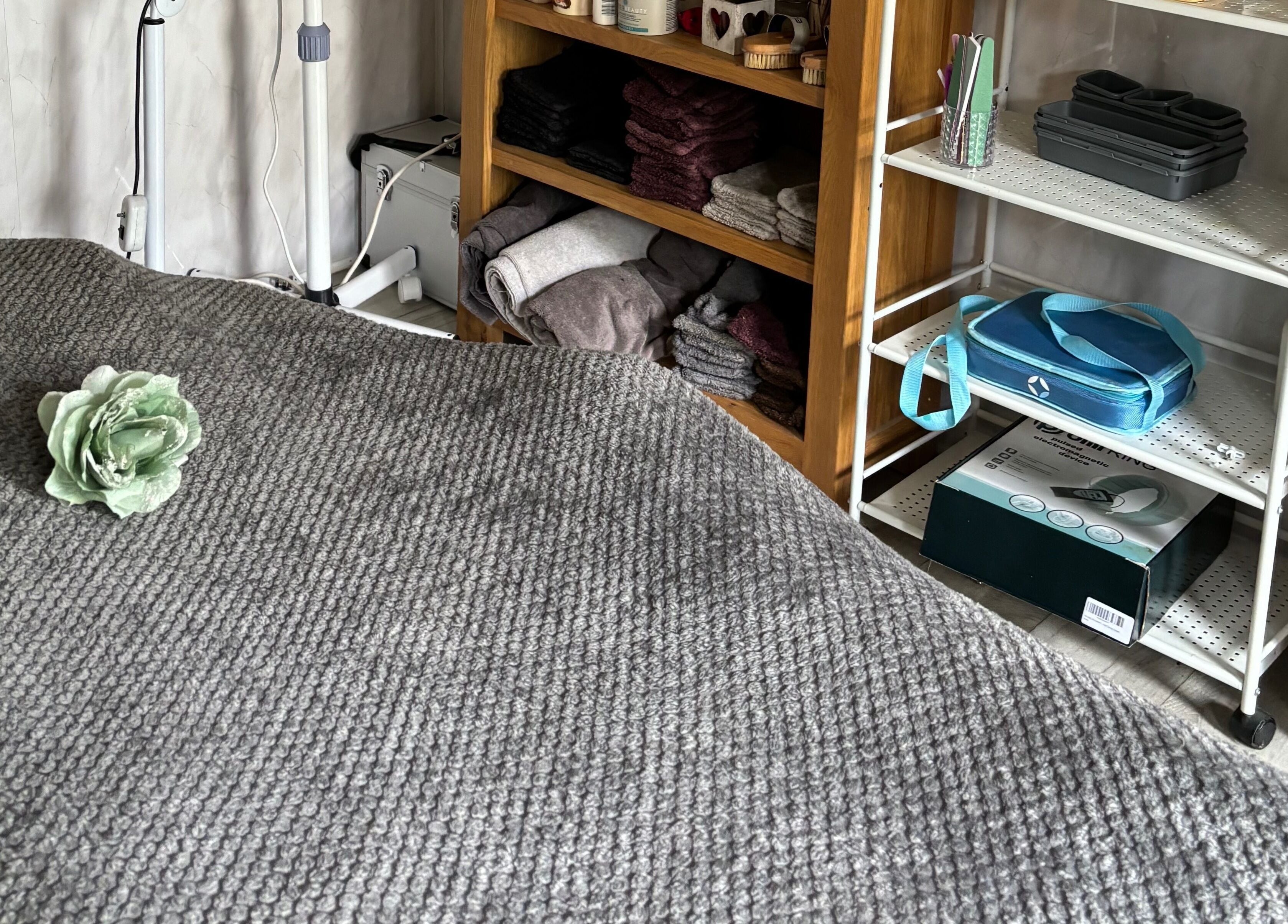 Massage table with a flower at Kerridwen, Cardiff, Wales, GB, showcasing a serene beauty treatment room.