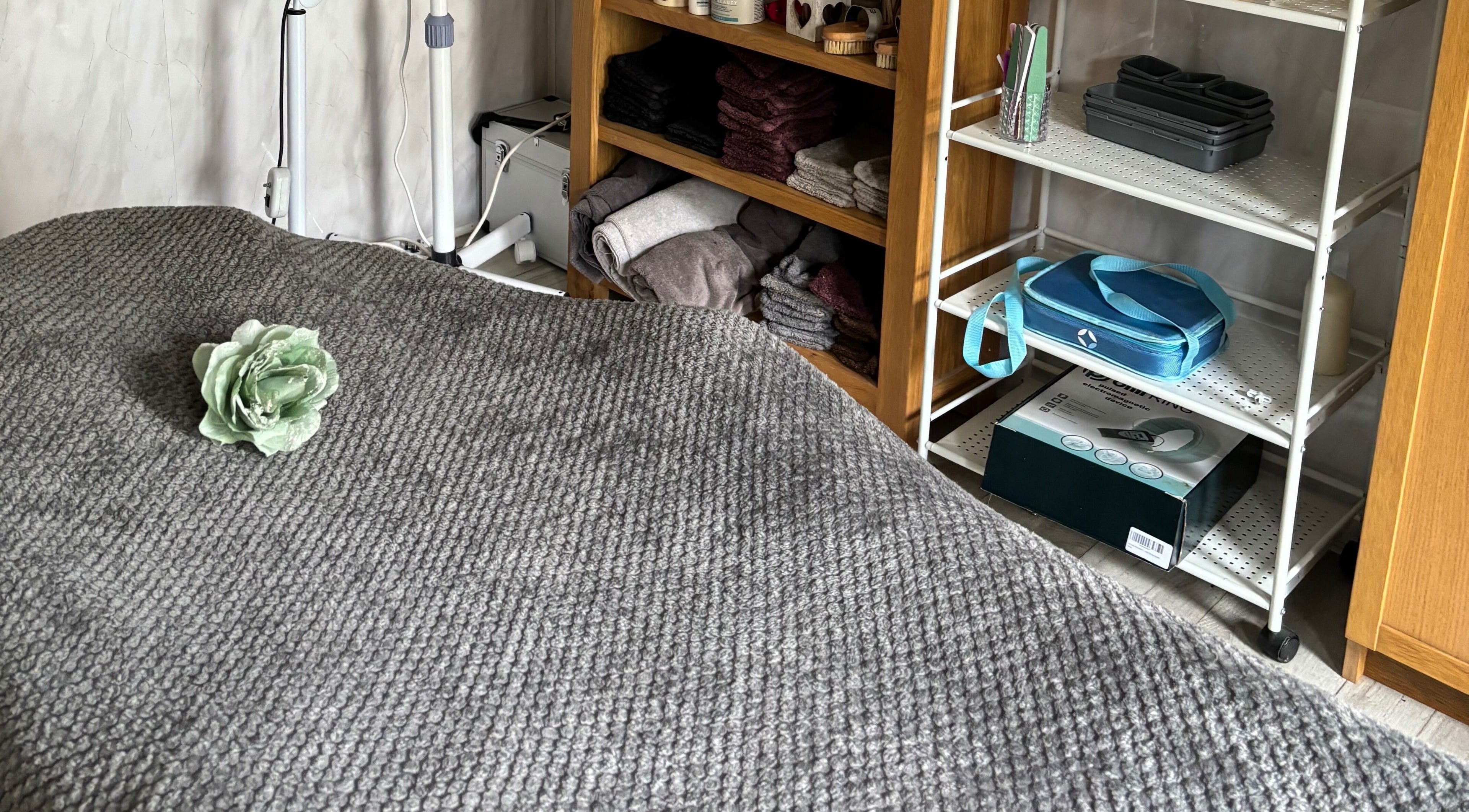 Massage table with a flower at Kerridwen, Cardiff, Wales, GB, showcasing a serene beauty treatment room.