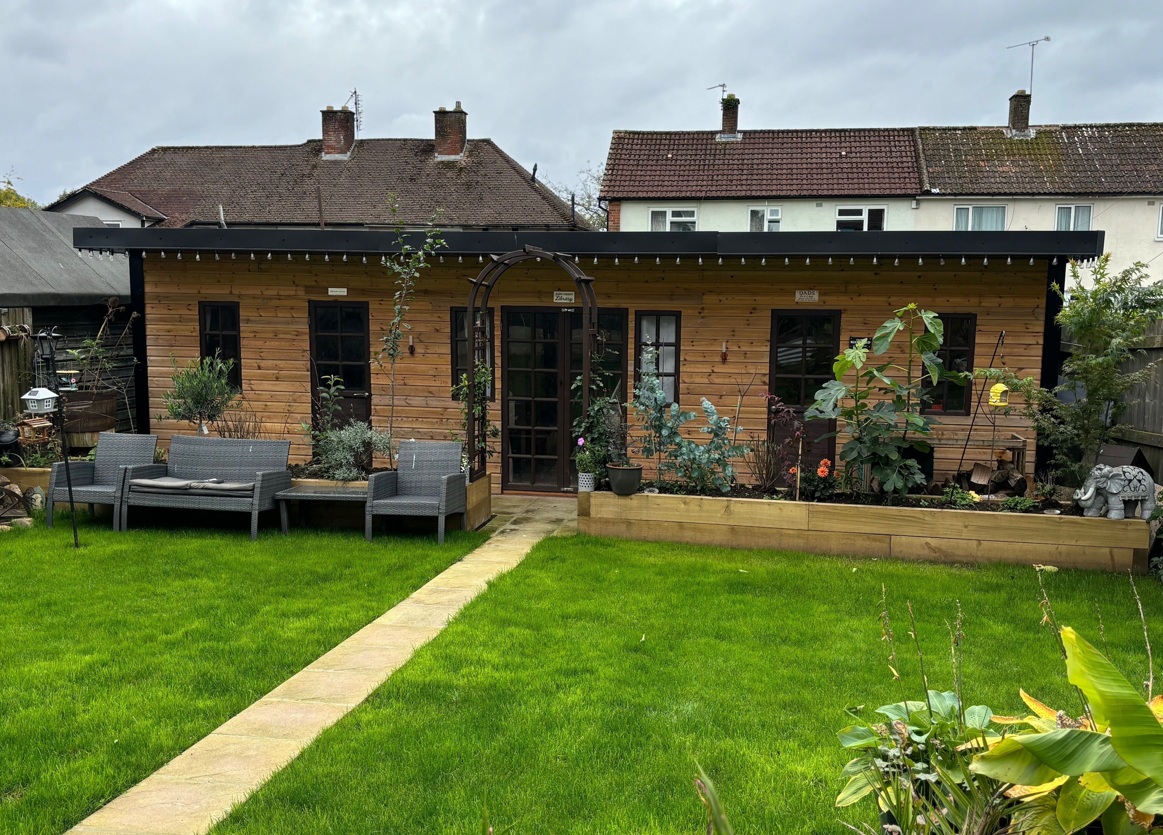 Charming wooden cabin with lush garden at Kerridwen, Cardiff, Wales, GB offers a tranquil retreat.