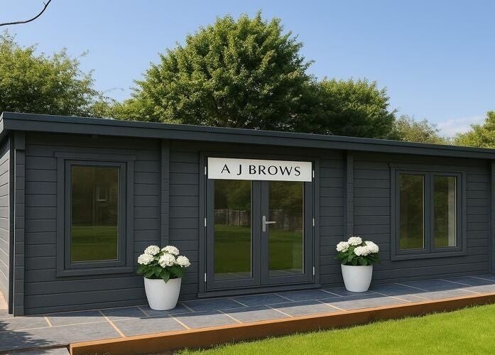 Charming exterior of A J BROWS - SURREY, nestled in Godalming, England, GB among lush greenery.